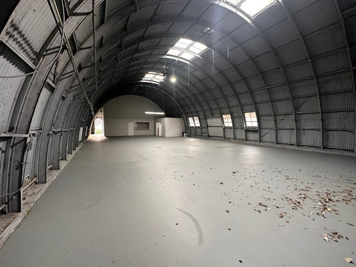 Large Empty Warehouse with high arched metal ceiling and lobby loft space - Image 4