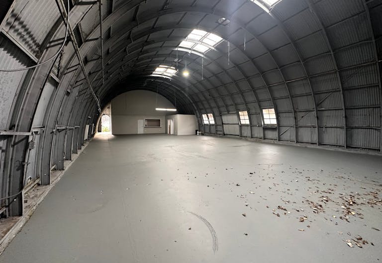 Large Empty Warehouse with high arched metal ceiling and lobby loft space - Image 4