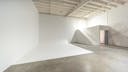 High-ceiling photo studio with a cyclorama wall