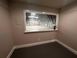 Large Empty Warehouse with high arched metal ceiling and lobby loft space - Image 7