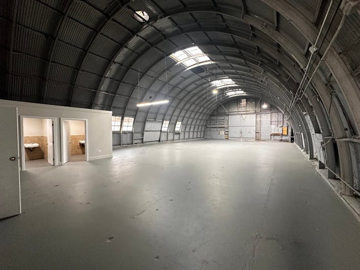 Large Empty Warehouse with high arched metal ceiling and lobby loft space - Image 2