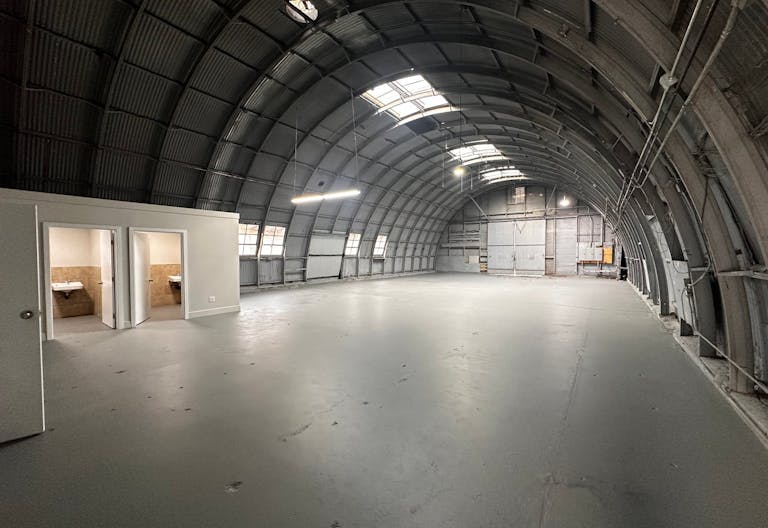Large Empty Warehouse with high arched metal ceiling and lobby loft space - Image 2