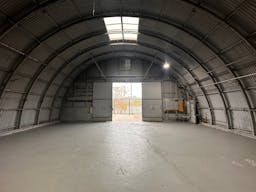 Large Empty Warehouse with high arched metal ceiling and lobby loft space - Image 0