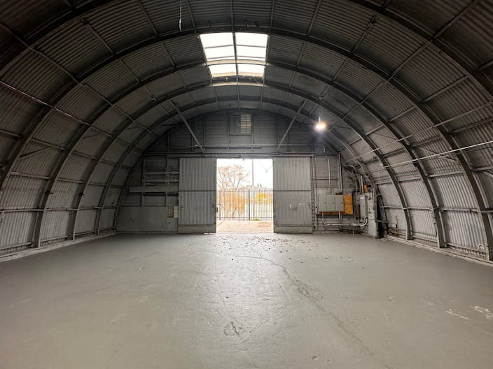 Large Empty Warehouse with high arched metal ceiling and lobby loft space - Image 0