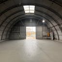 Large Empty Warehouse with high arched metal ceiling and lobby loft space