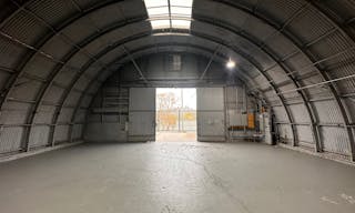 Large Empty Warehouse with high arched metal ceiling and lobby loft space - Image 0