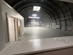 Large Empty Warehouse with high arched metal ceiling and lobby loft space - Image 1