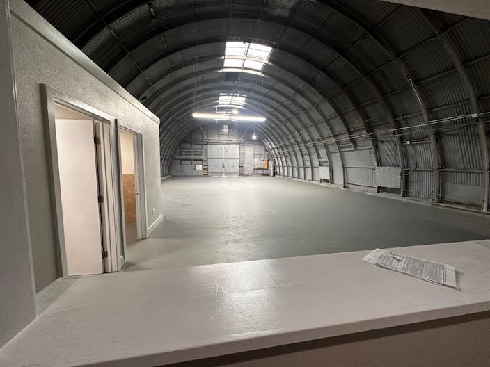 Large Empty Warehouse with high arched metal ceiling and lobby loft space - Image 1
