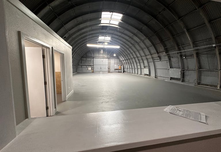 Large Empty Warehouse with high arched metal ceiling and lobby loft space - Image 1