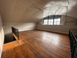 Large Empty Warehouse with high arched metal ceiling and lobby loft space - Image 6