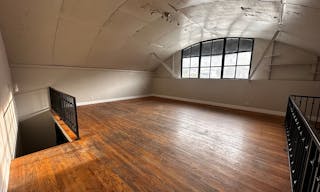 Large Empty Warehouse with high arched metal ceiling and lobby loft space - Image 6